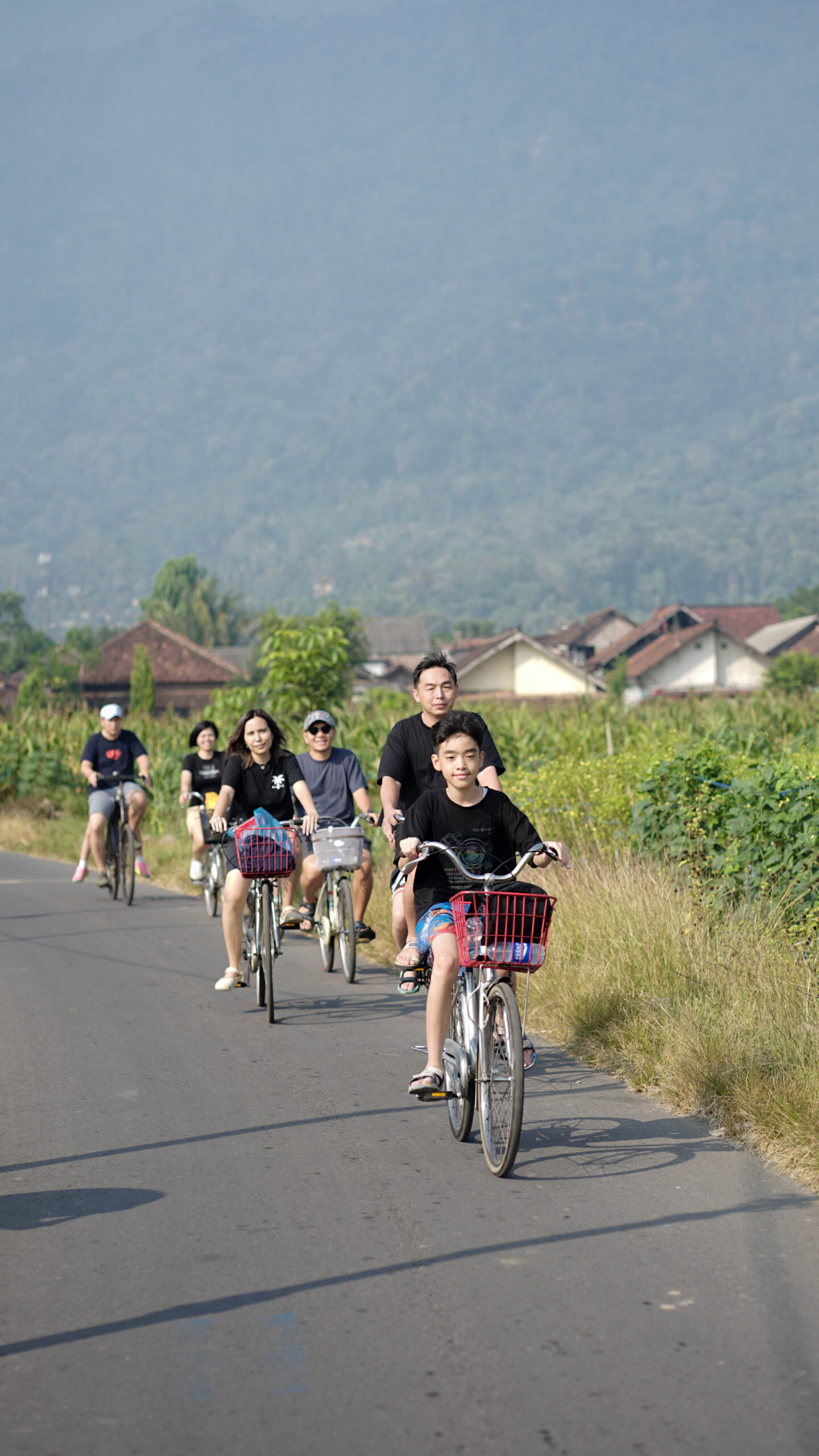 Experience Sunrise & Gowes Sepeda di Bukit Rhema Borobudur 5 Rombongan gowes sepeda di Borobudur melewati persawahan hijau dengan Bukit Rhema di kejauhan